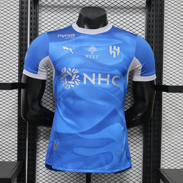 26-27 Al Hilal (Riad) visitante (opciones: sin/con publicidad), local azul S-3XL